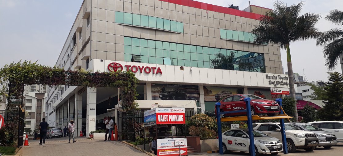 Harsha Toyota showroom interior with Toyota cars display area, modern dealership space showcasing latest Toyota cars and customer service section