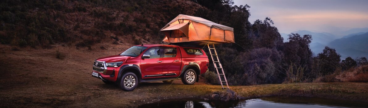 Toyota Hilux car with tent canopy setup showing adventure-ready features, outdoor lifestyle use, and premium Hilux car versatility for travel.