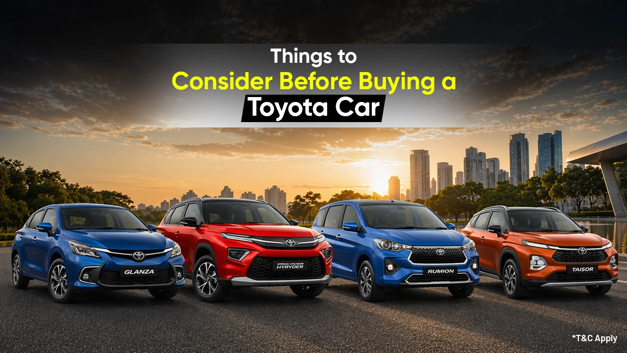 Toyota cars lineup including Glanza, Urban Cruiser Hyryder, Rumion and Taisor displayed on a city road at sunset, highlighting key considerations before buying a Toyota vehicle.